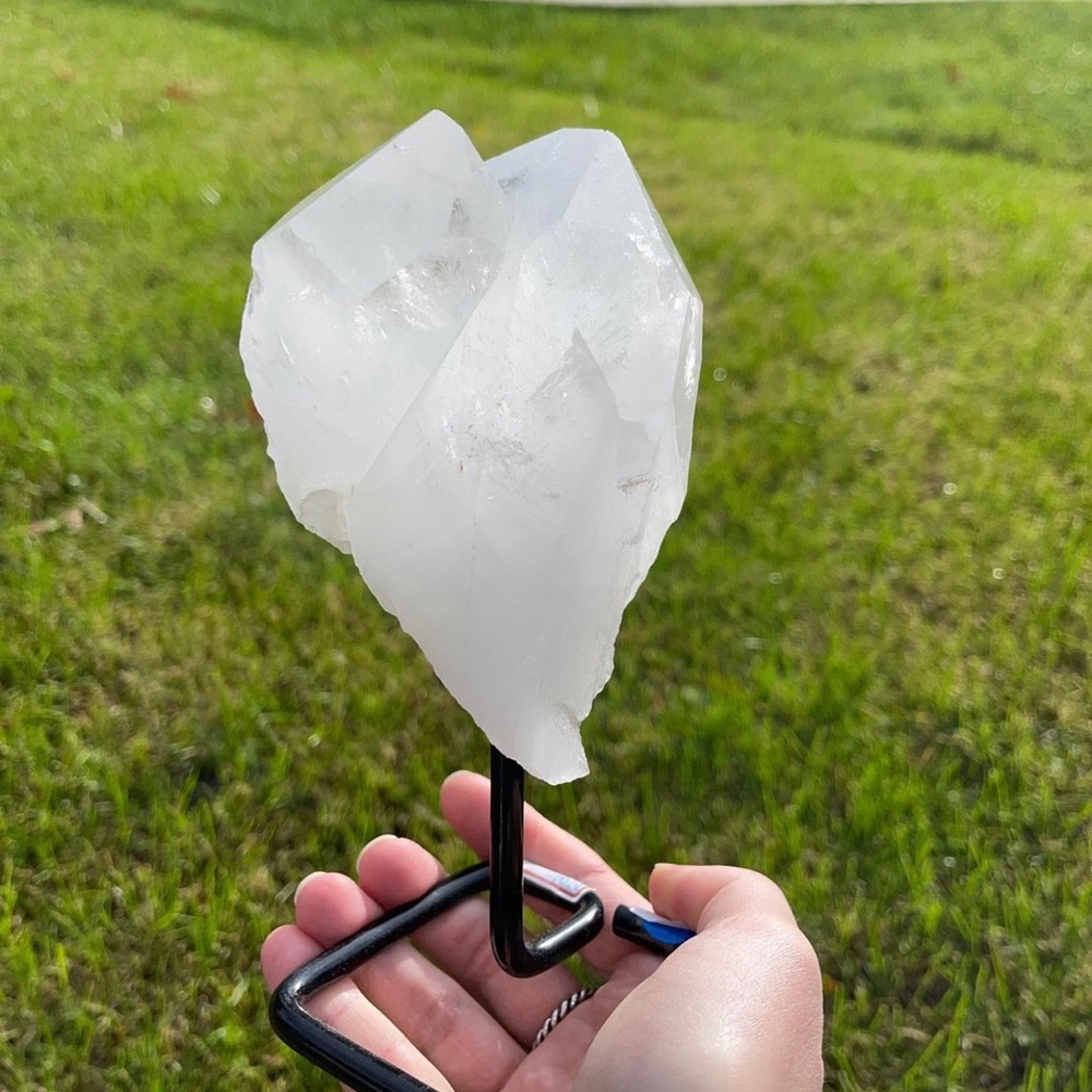Quartz point on metal stand. (Crystals)